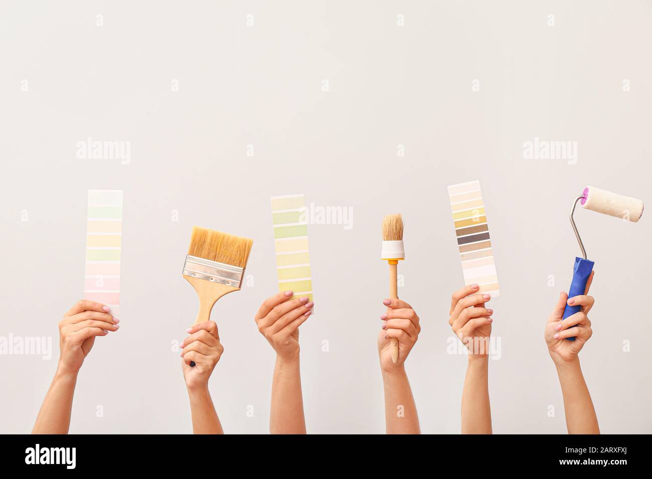 Female hands with painter's tools on white background Stock Photo - Alamy