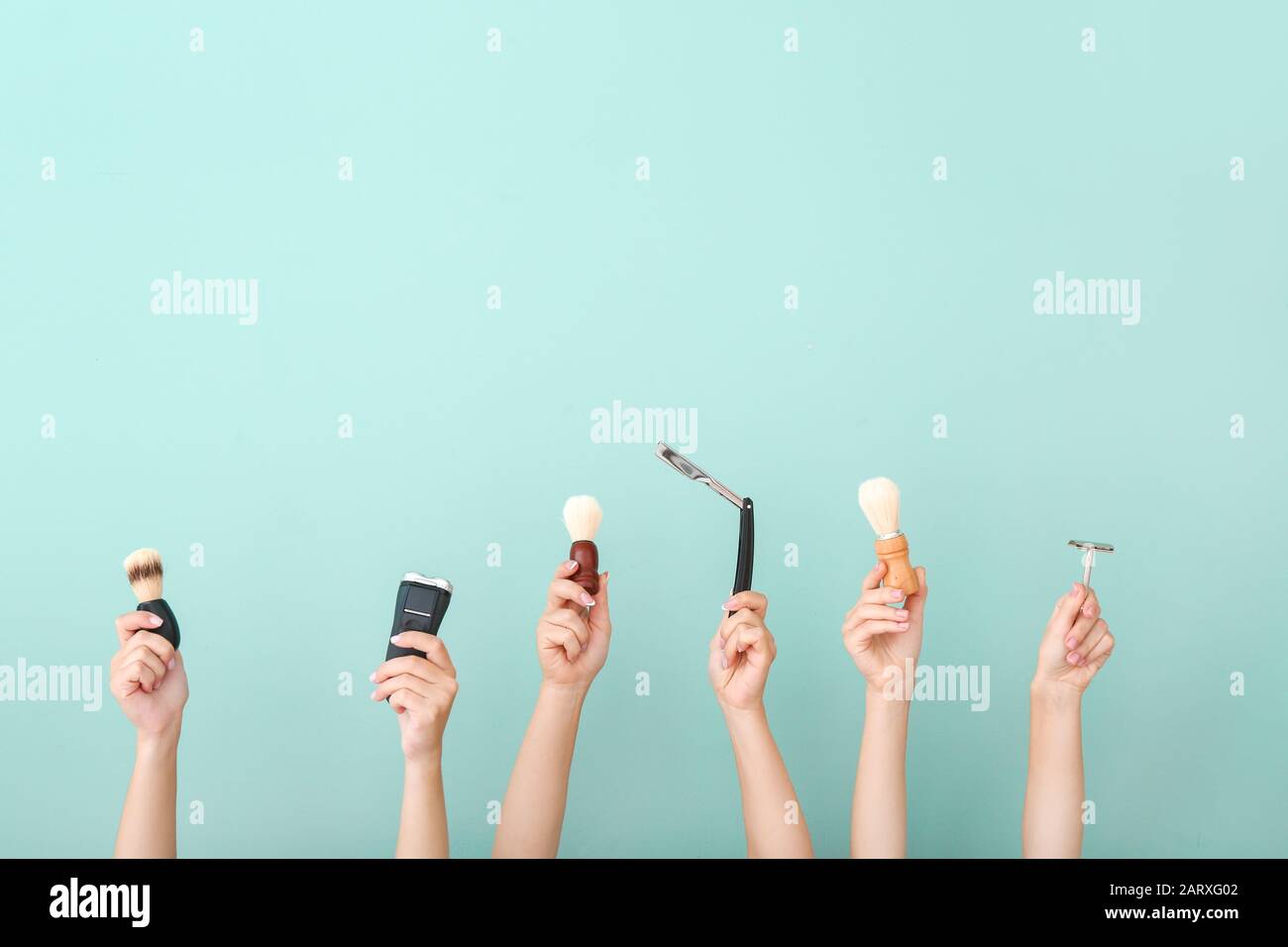 Hands with different tools for shaving on color background Stock Photo