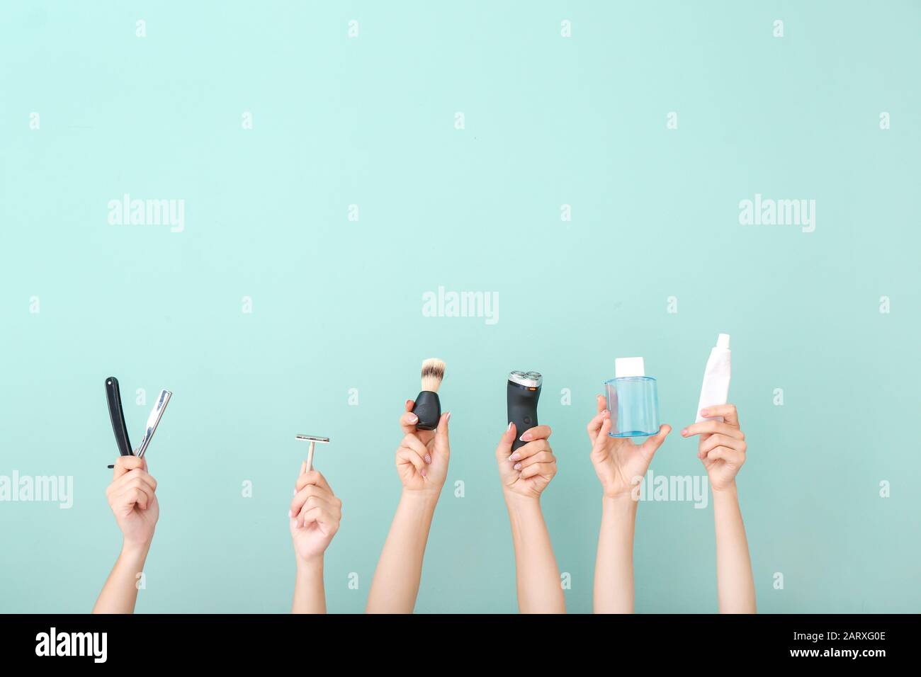 Hands with different tools for shaving on color background Stock Photo
