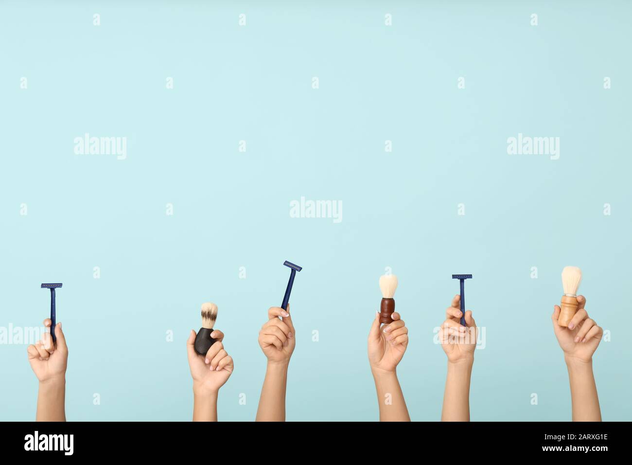 Hands with different tools for shaving on color background Stock Photo