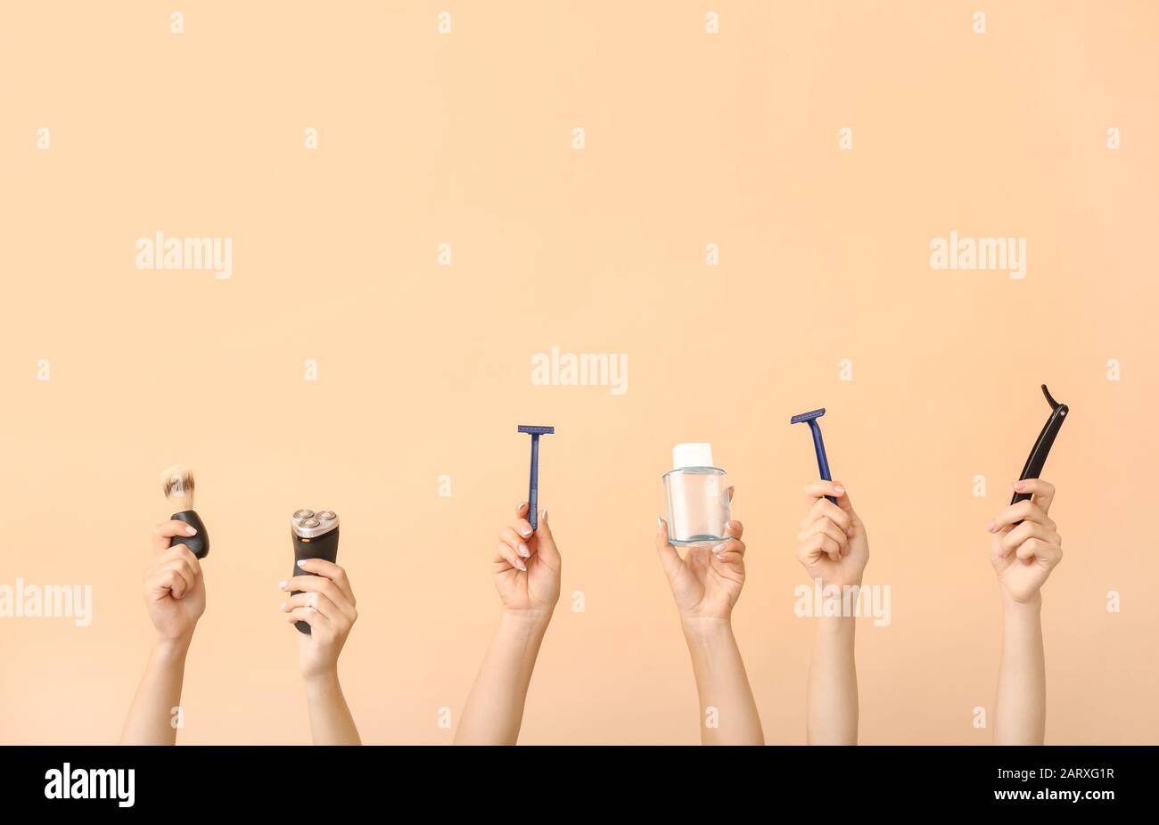 Hands with different tools for shaving on color background Stock Photo