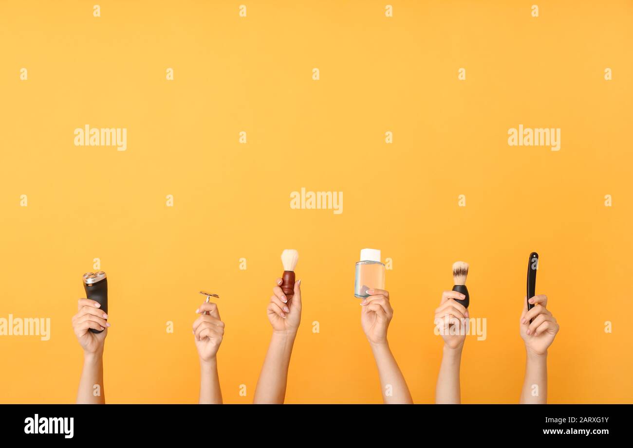 Hands with different tools for shaving on color background Stock Photo
