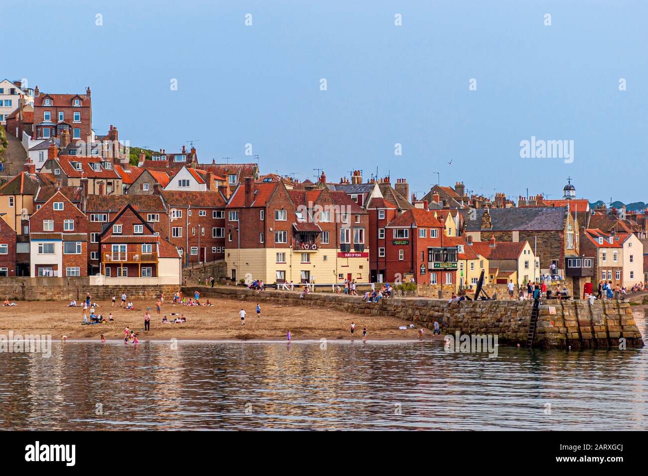 Whitby Harbour/River Esk with houses and tourists on beach, UK Stock