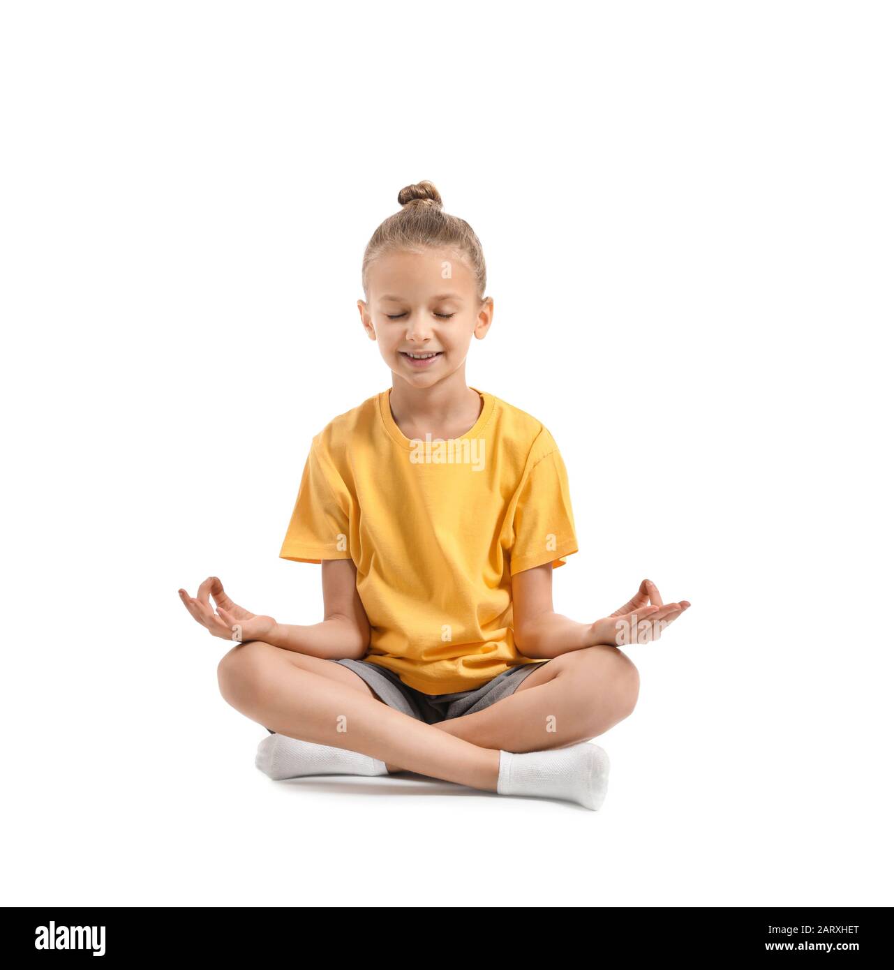 Little girl practicing yoga on white background Stock Photo - Alamy