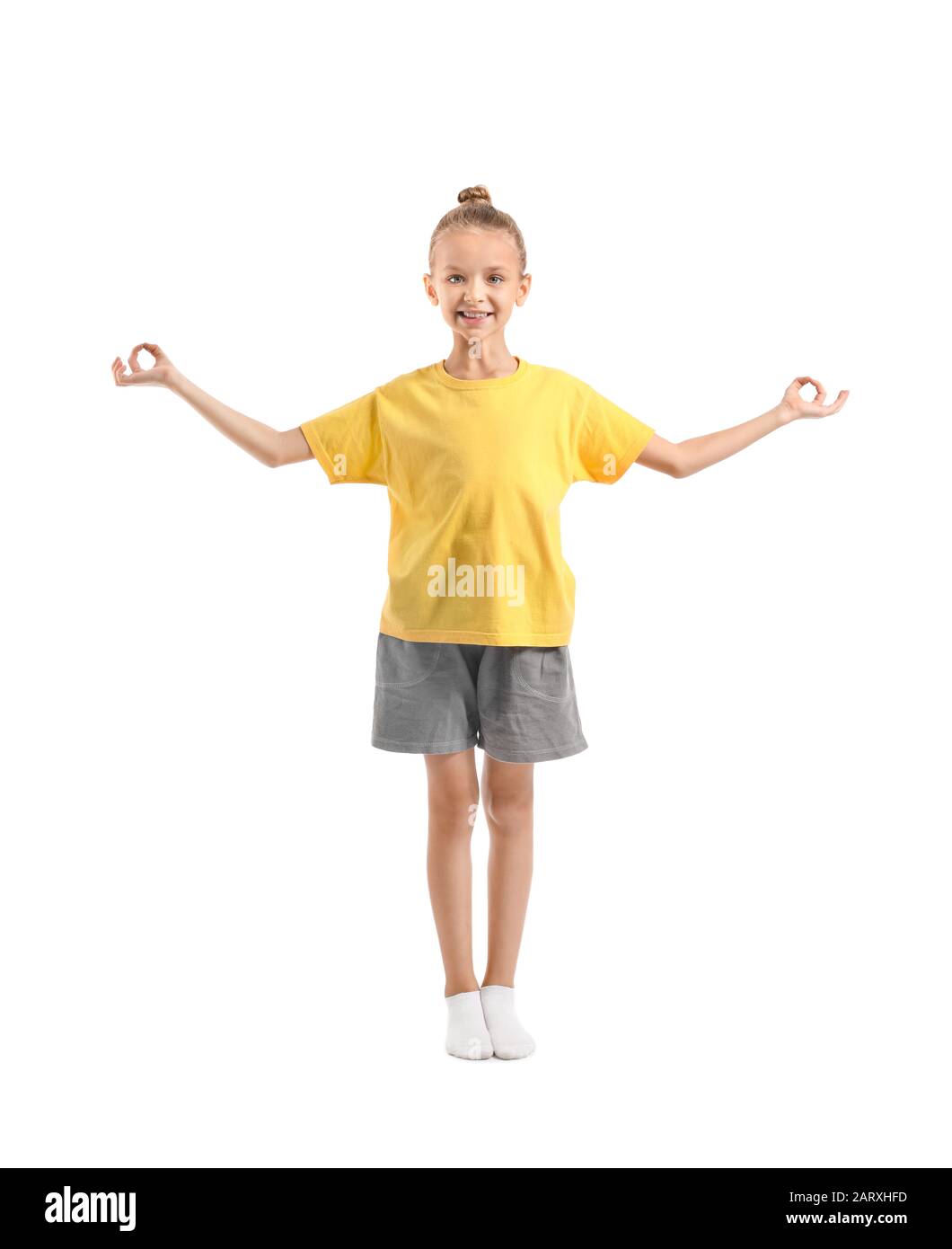 Little girl practicing yoga on white background Stock Photo - Alamy