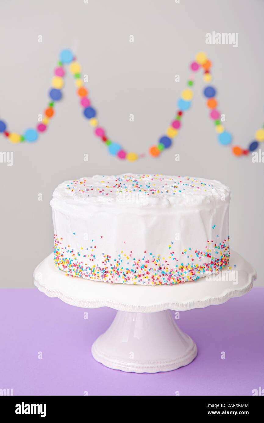 Tasty Birthday cake on table against grey background Stock Photo - Alamy