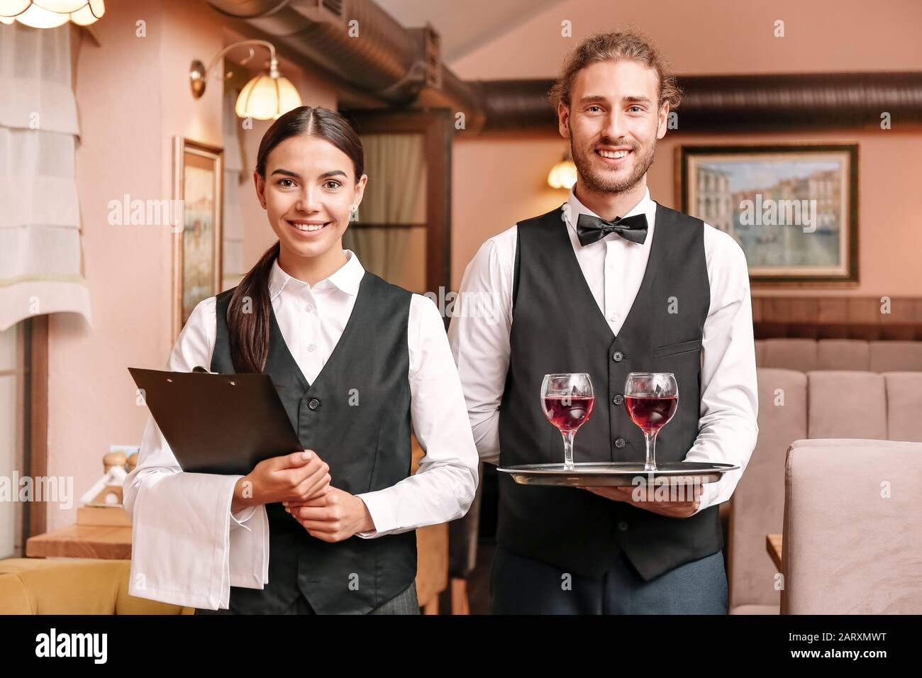 Portrait of young waiters in restaurant Stock Photo