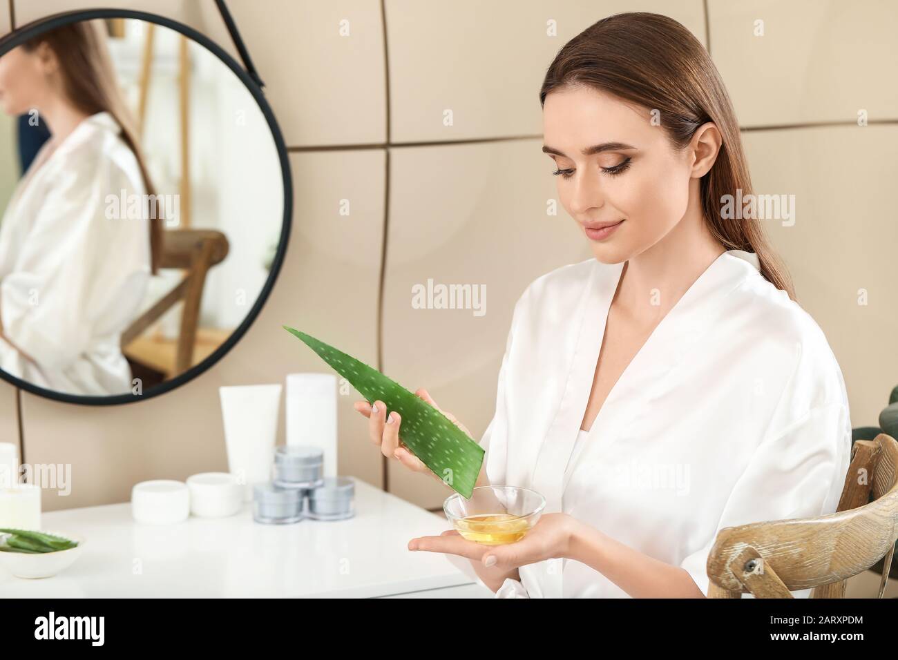 Beautiful young woman using aloe vera in bathroom Stock Photo Alamy