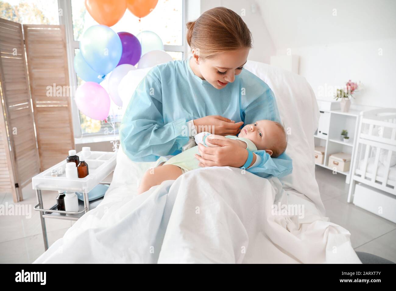 Young mother with newborn baby in maternity hospital Stock Photo - Alamy