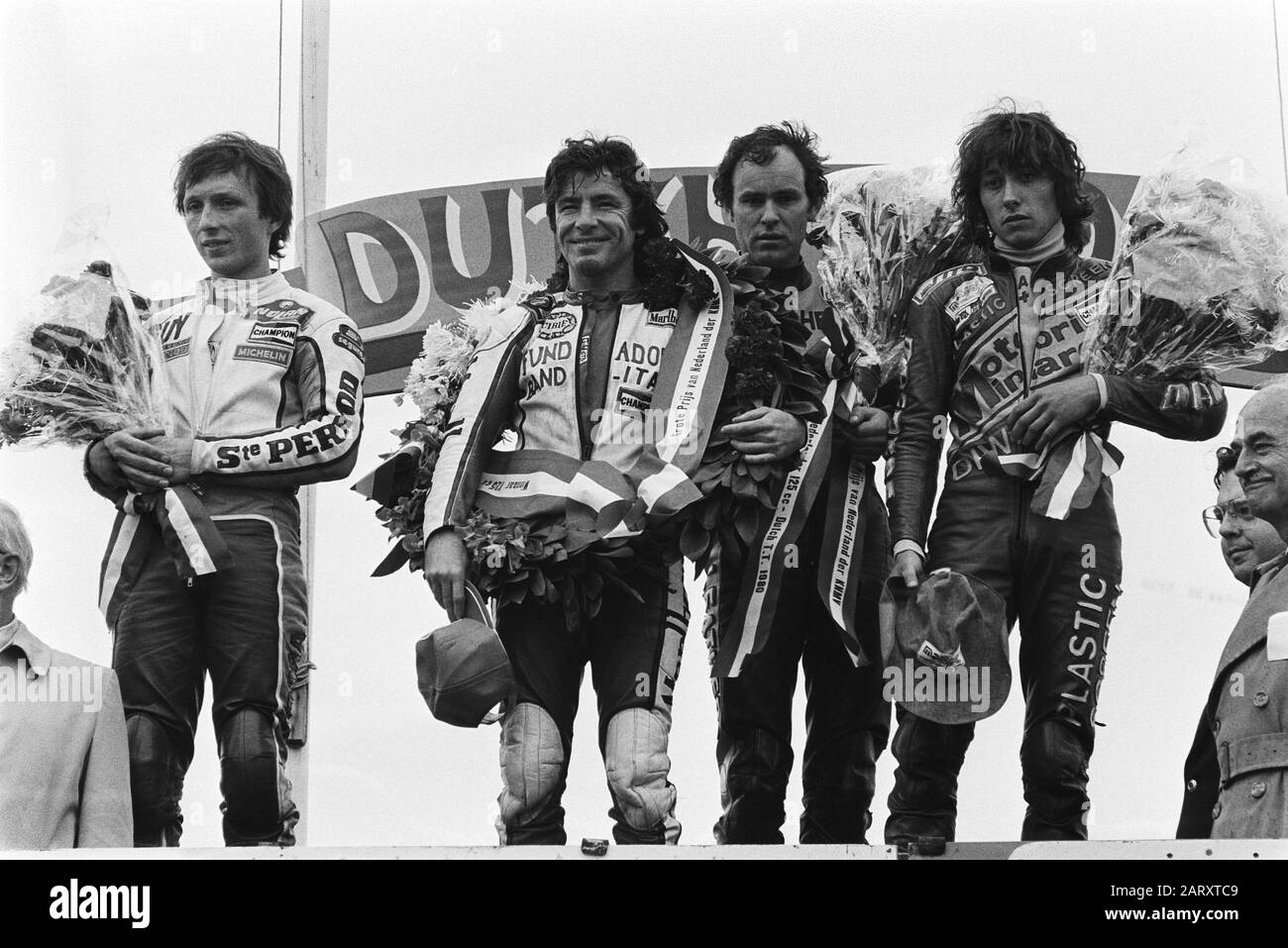 TT Assen 1980  TT Assen; ceremony after 125 cc race, v.l.n.r. Bertin (2nd), Nieto (1e), van Kessel (8e) (NL), Regianni (3rd) Date: 28 June 1980 Location: Axis Keywords: tributes, motorcycle drivers, motorcycle races , motorsport, sport Person name: Bertin, Guy, Kessel, Henk van, Nieto, Angel, Regianni, Loris Stock Photo