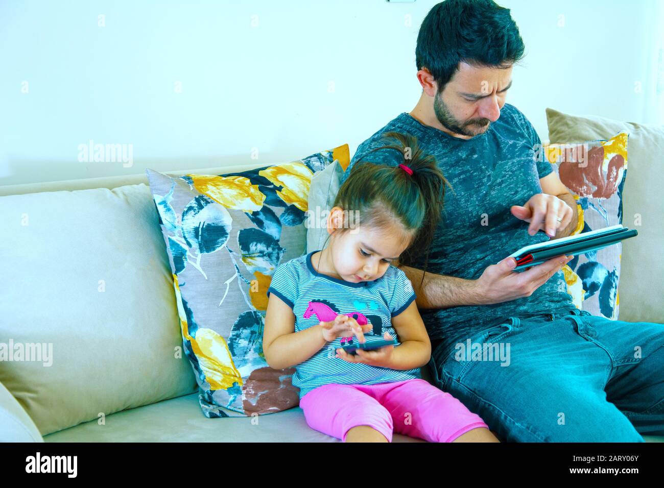 Father and his daughter playing game in notebook Stock Photo