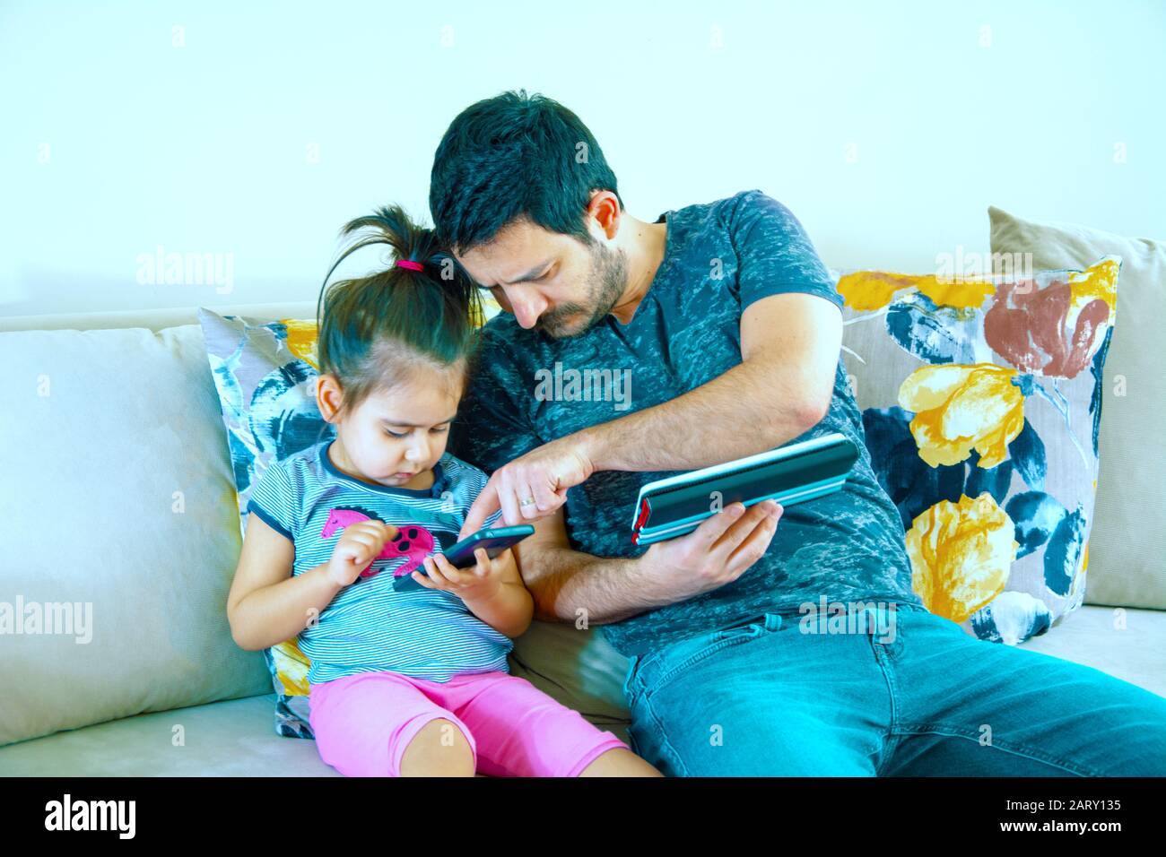 Father and his daughter playing game in notebook Stock Photo