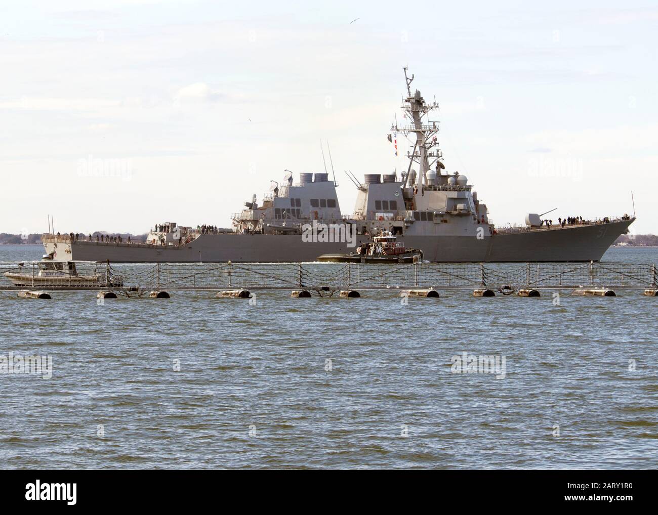 200128-N-KP445-1157 NORFOLK, Va. (Jan. 28, 2020) A tug boat escorts the guided missile destroyer USS Arleigh Burke (DDG 51) out to sea as the ship departs for sea trials. Arleigh Burke is in the final stage of its Dock Selected Restricted Availability (DSRA) conducted by NASSCO-General Dynamics. The Mid-Atlantic Regional Maintenance (MARMC) is providing oversight and management of the availability. (U.S. Navy Photo by Hendrick L. Dickson/Released) Stock Photo