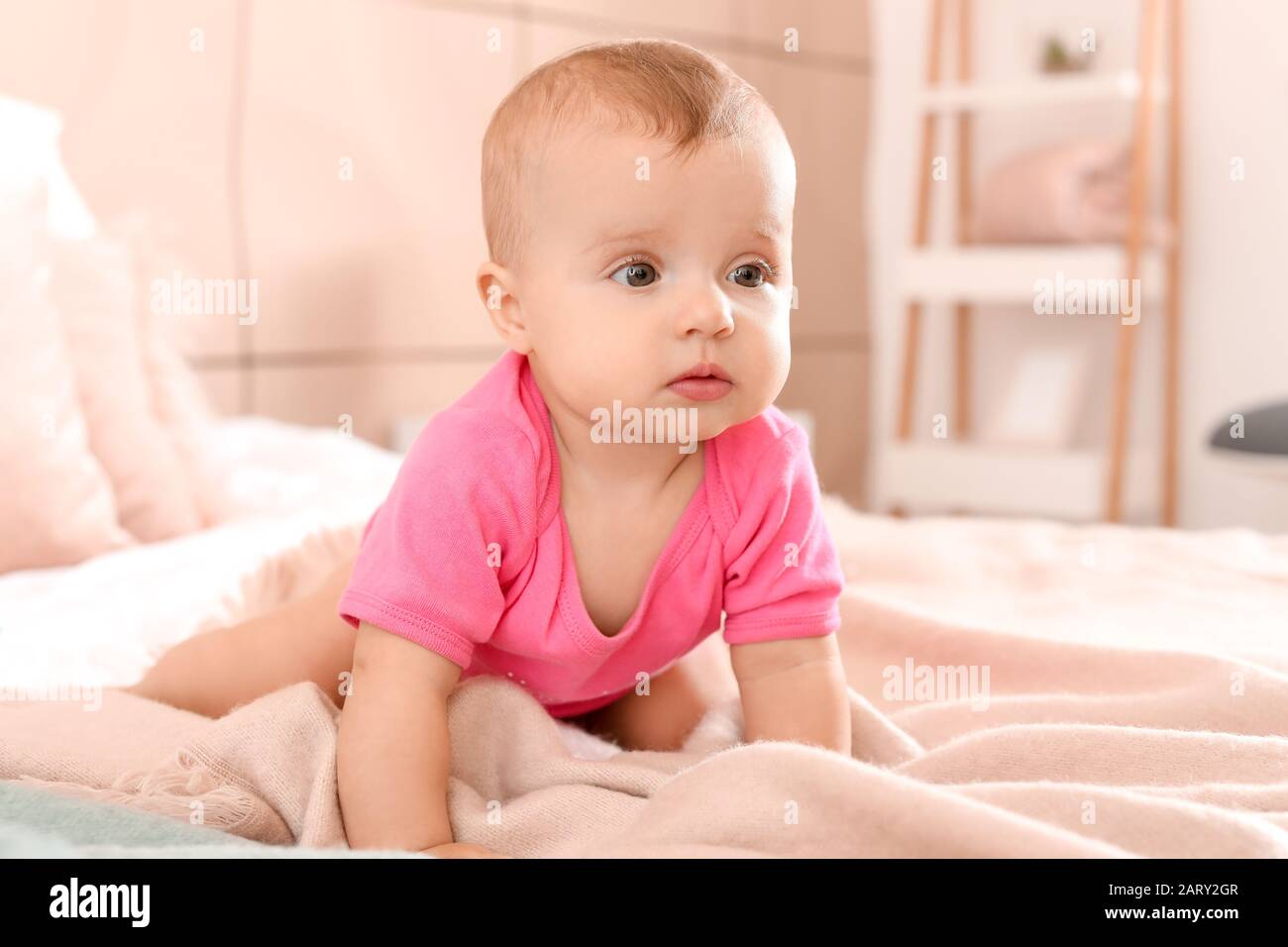 Portrait of cute little baby on bed at home Stock Photo - Alamy