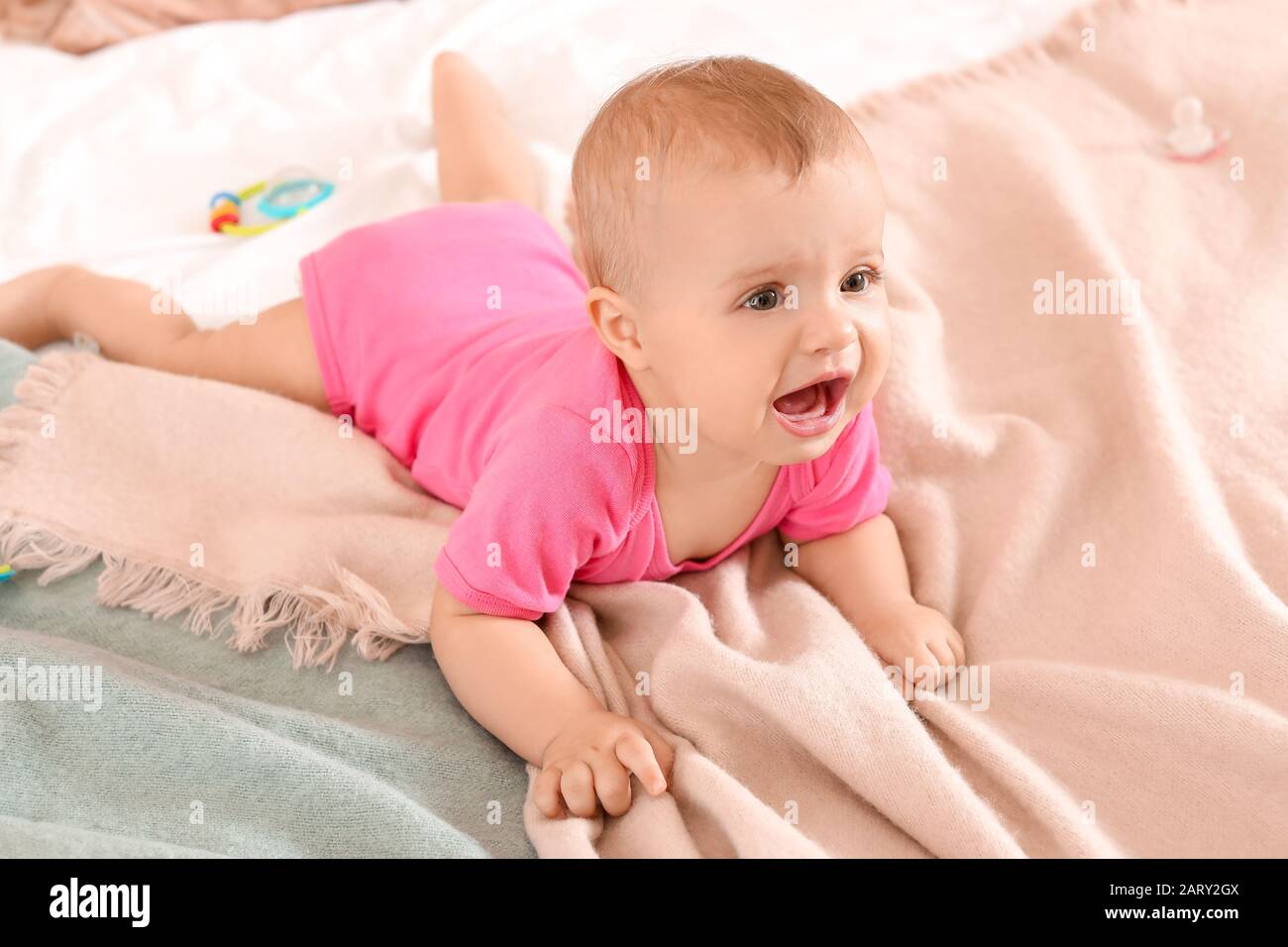Portrait of cute little baby on bed at home Stock Photo Alamy