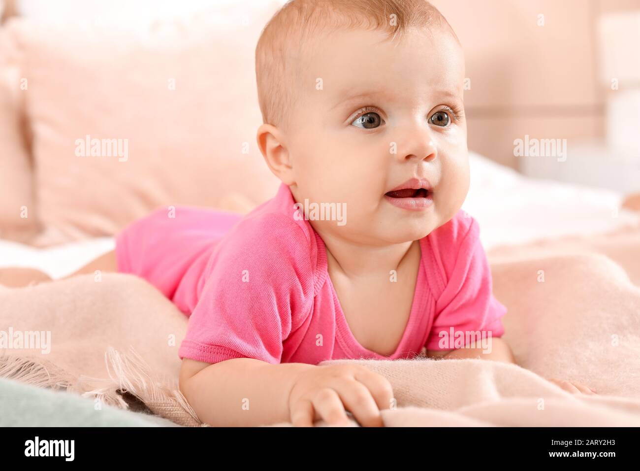 Portrait of cute little baby on bed at home Stock Photo - Alamy