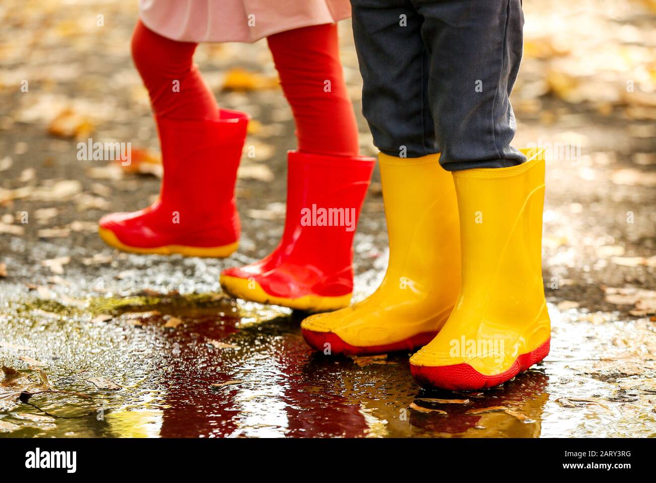 Cute little children with gumboots on autumn day Stock Photo