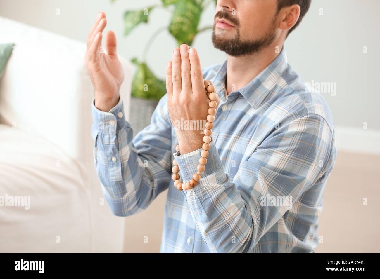 Muslim man praying at home Stock Photo