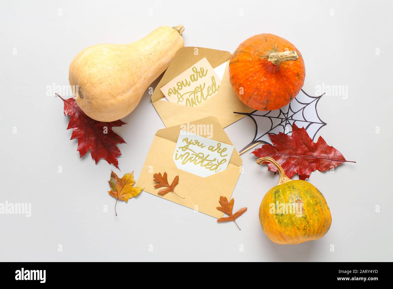 Invitations with envelopes and autumn decor on white background Stock Photo