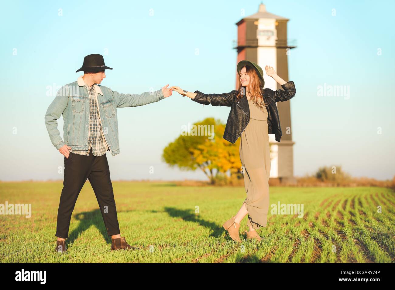 Happy young couple dancing in countryside Stock Photo