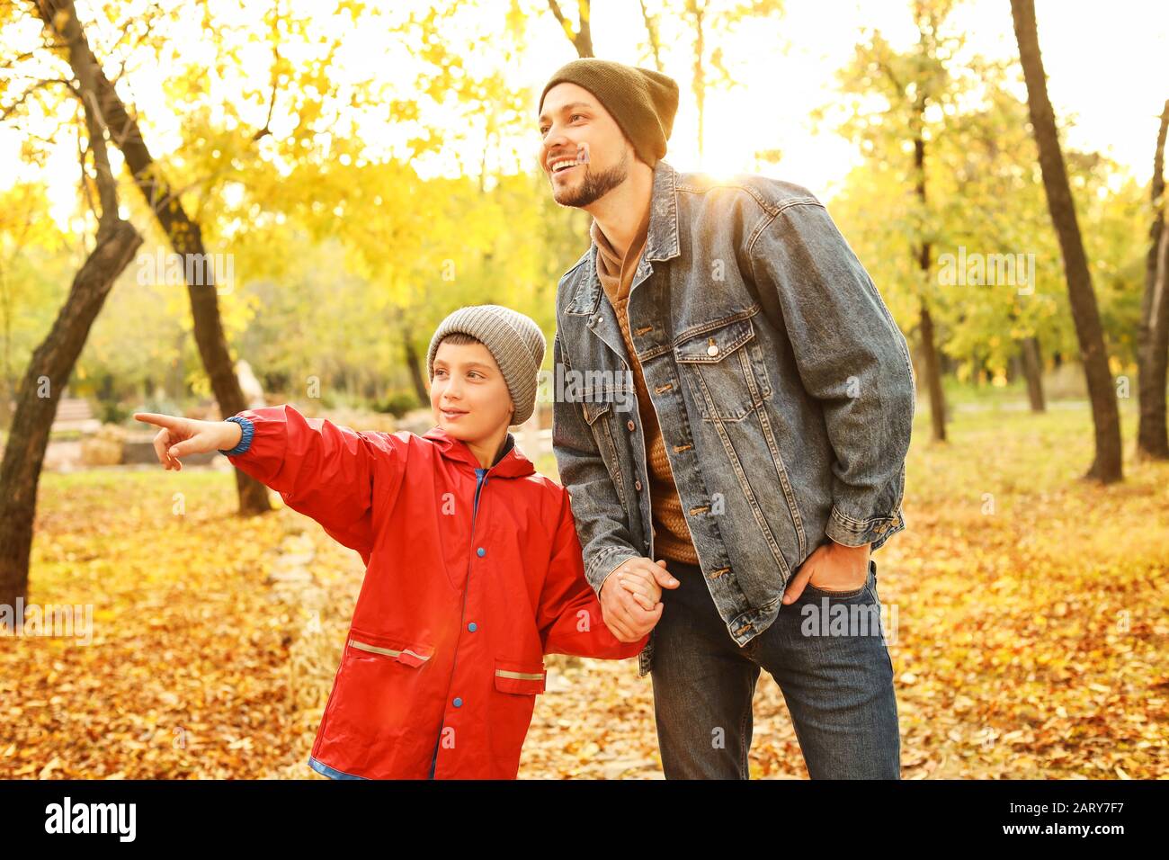Happy father and son in autumn park Stock Photo - Alamy