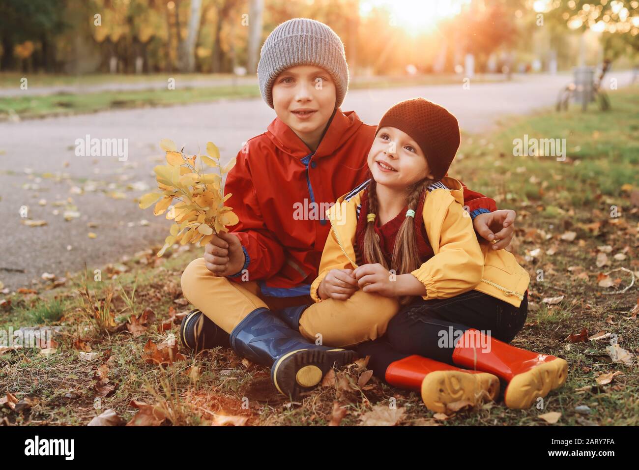 Happy children resting in autumn park Stock Photo