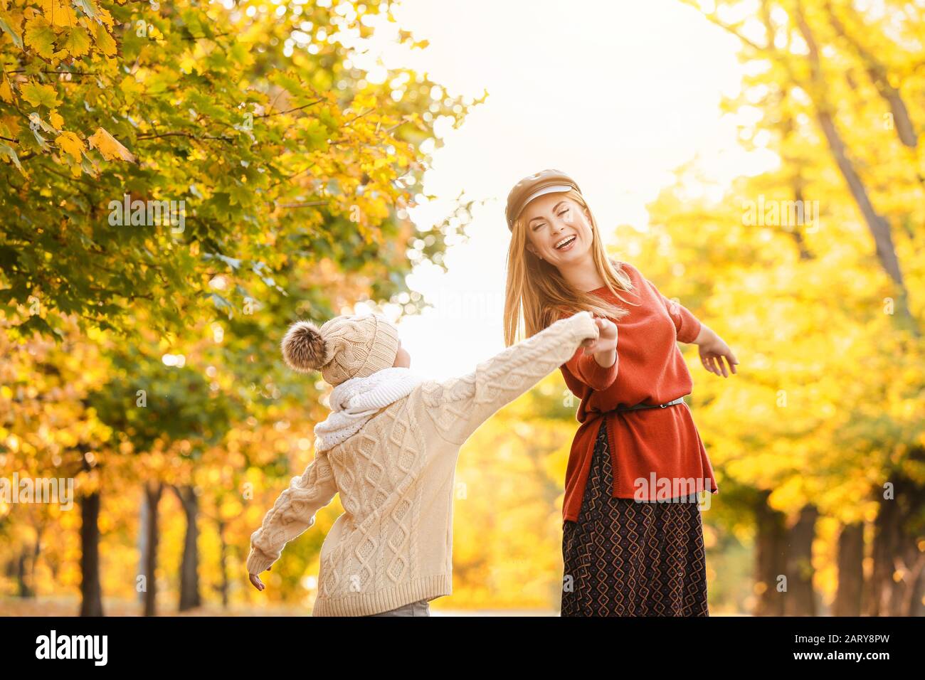 Happy mother and little daughter having fun in autumn park Stock Photo ...