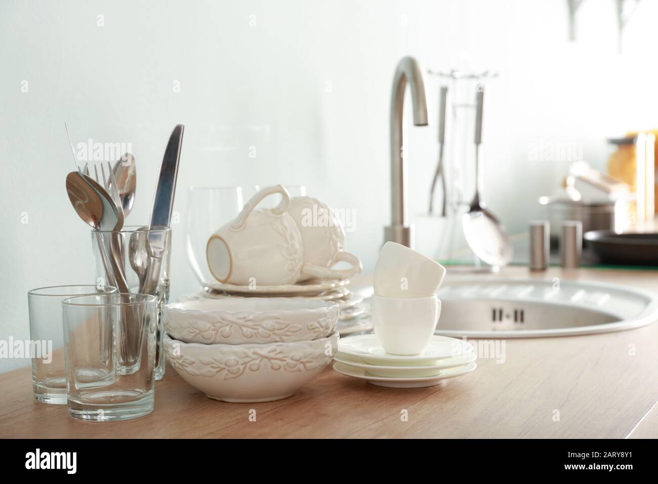 Set of clean dishware near kitchen sink Stock Photo Alamy