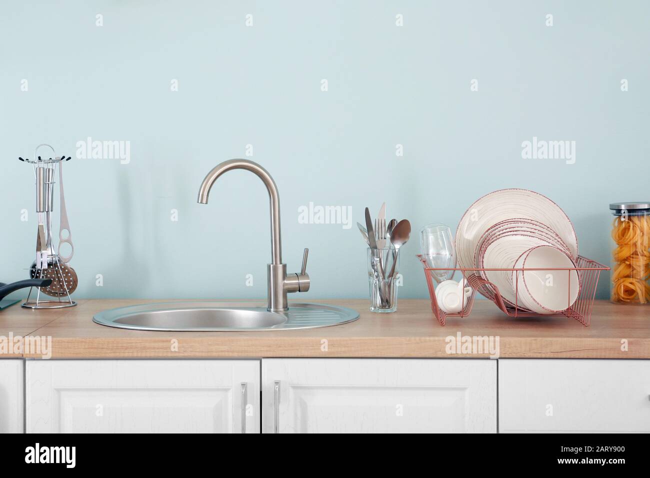 Set of clean dishware near kitchen sink Stock Photo Alamy
