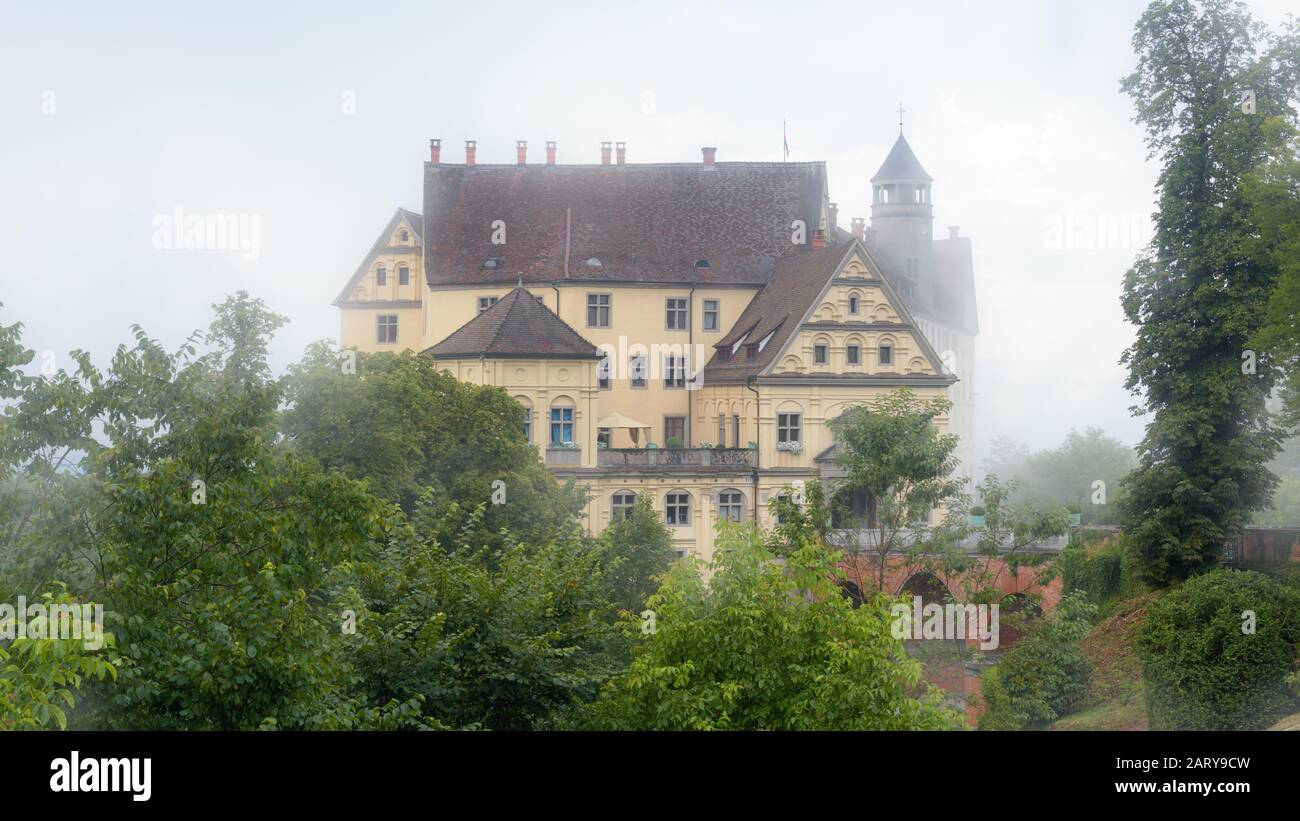 Castle of Heiligenberg in mist, Linzgau, Germany. This Renaissance castle is a landmark of Baden-Wurttemberg. Scenic view of mystery castle in foggy g Stock Photo