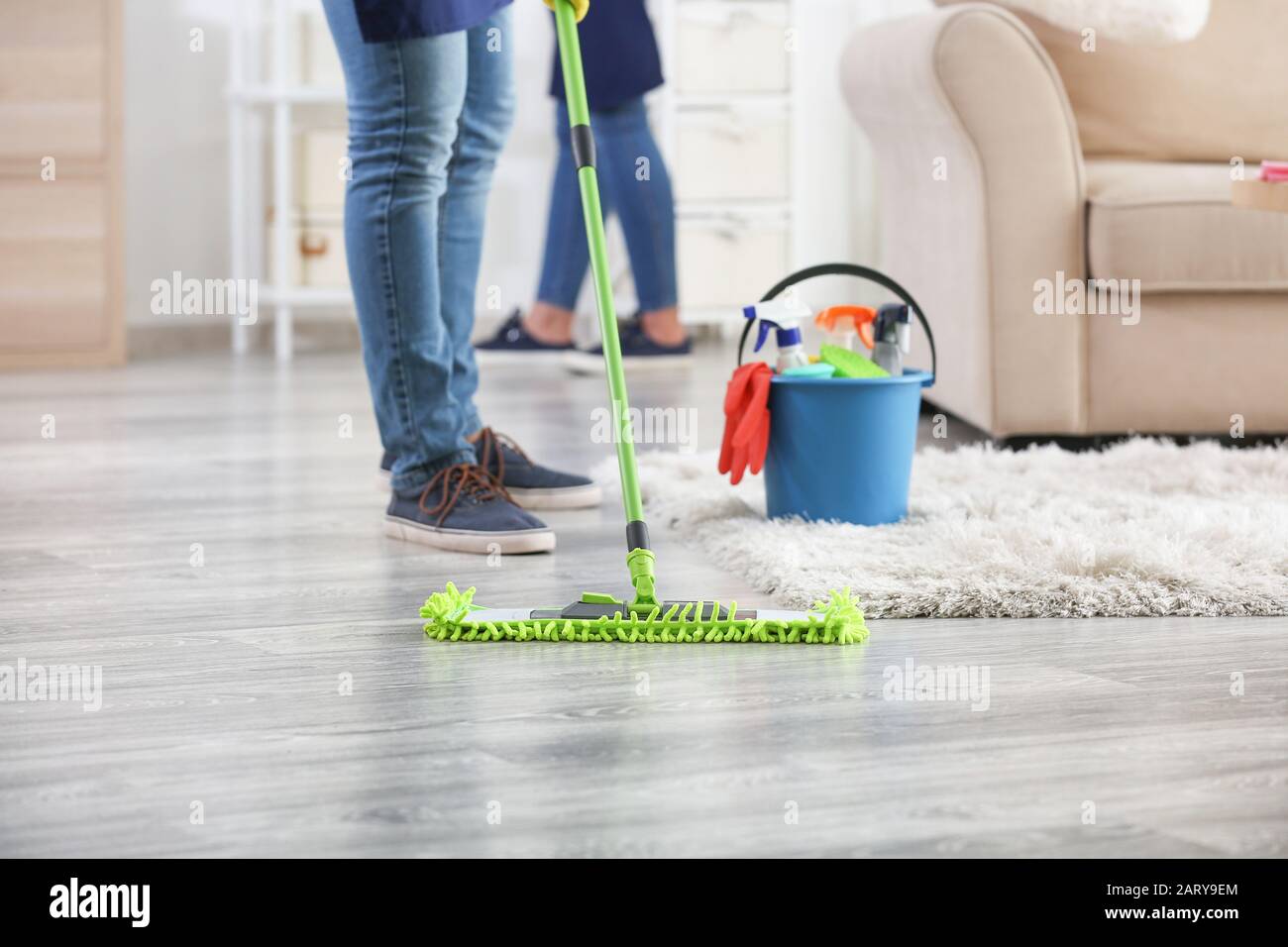 Male janitor mopping floor in room Stock Photo