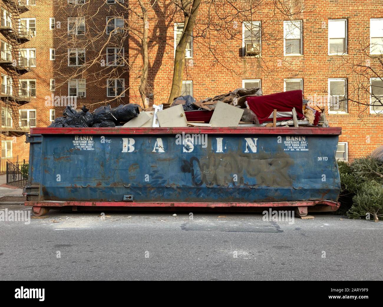 Dumpster outside an apartment building where an apartment is being