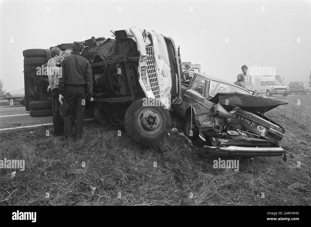 Accident road Amsterdam/The Hague by fog Truck on its side after