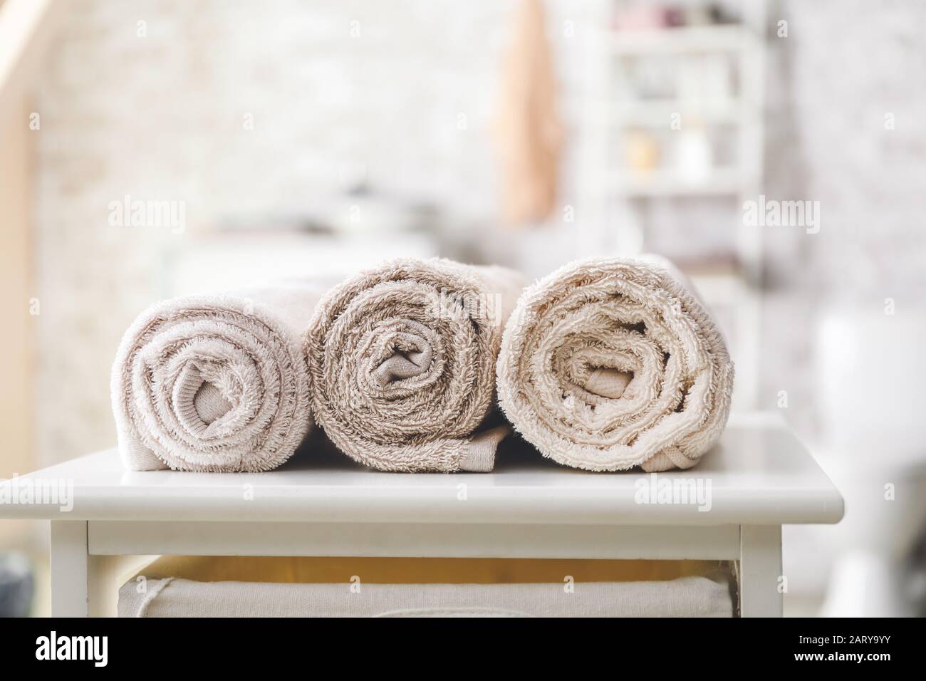 Clean and Rolled Towels on Bathroom Table Close To Tub Stock Image - Image  of beauty, bath: 261918459