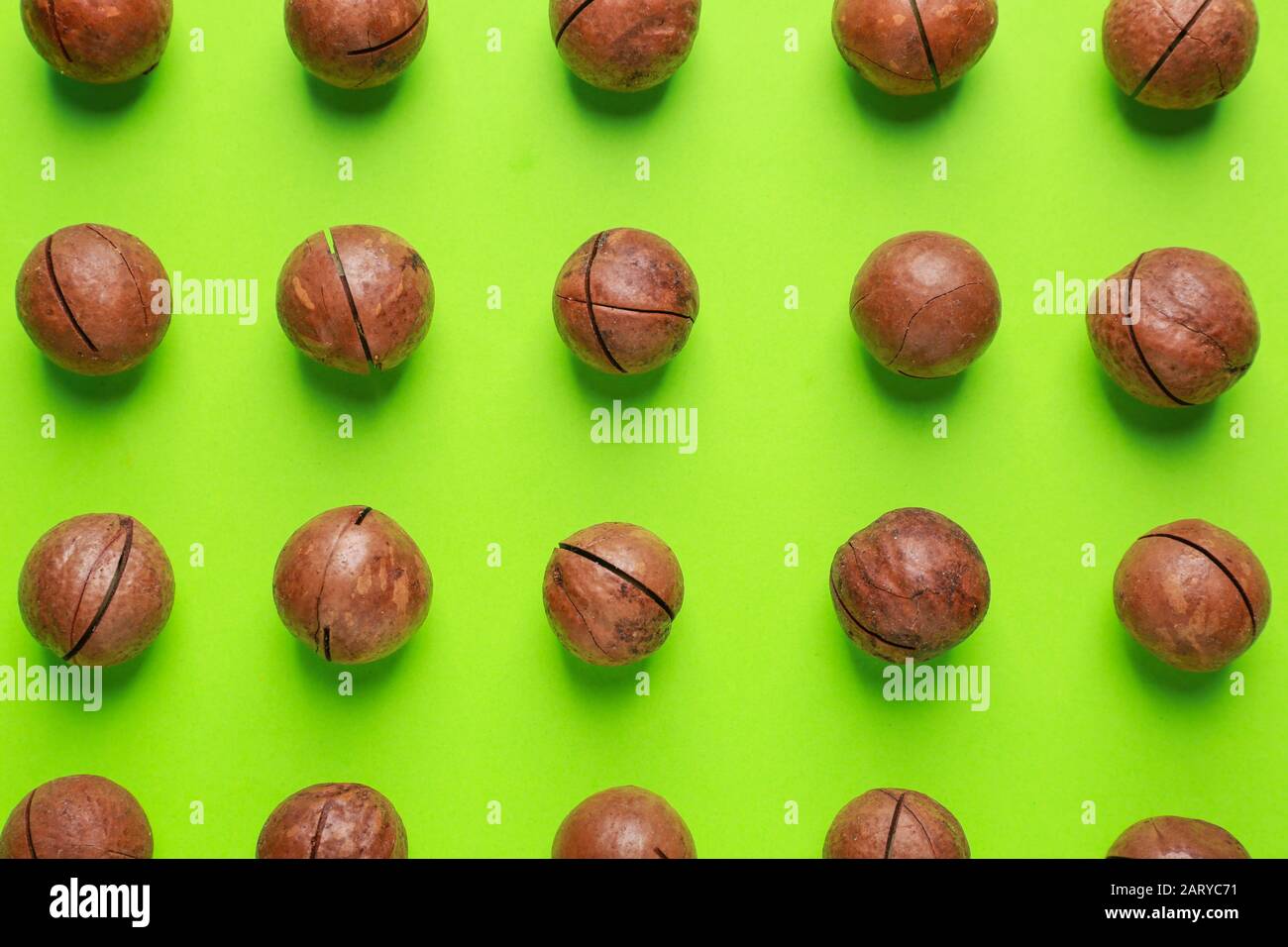 Tasty macadamia nuts on color background Stock Photo