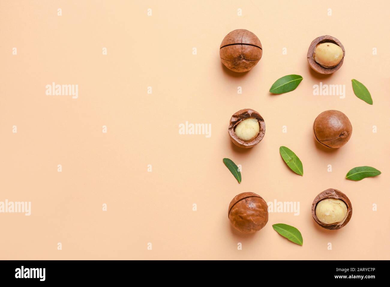 Tasty macadamia nuts on color background Stock Photo