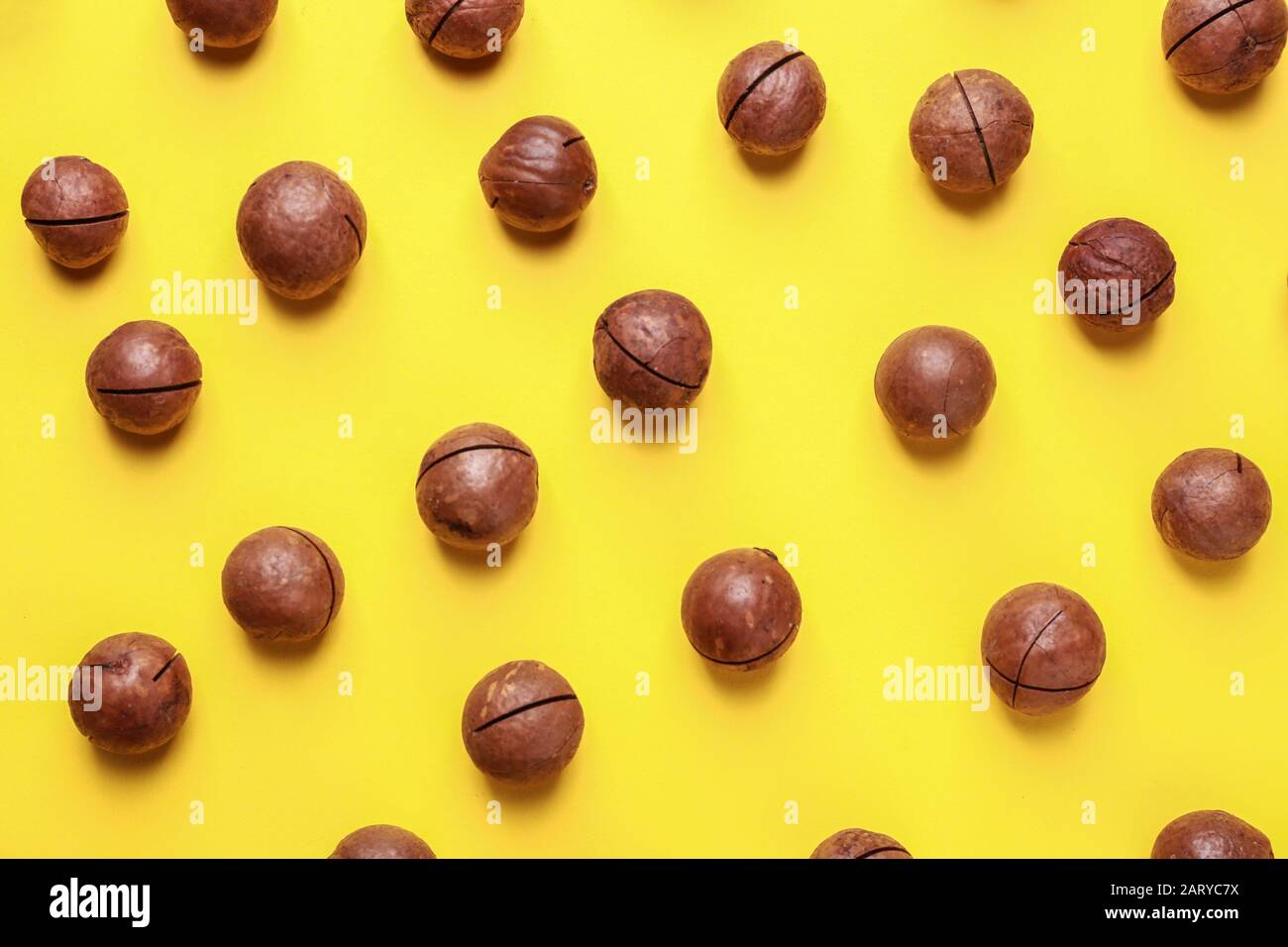 Tasty macadamia nuts on color background Stock Photo