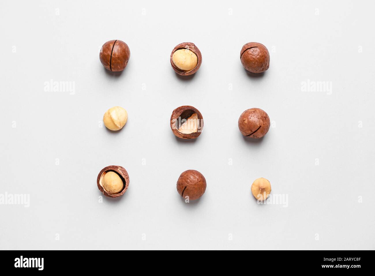 Tasty macadamia nuts on light background Stock Photo