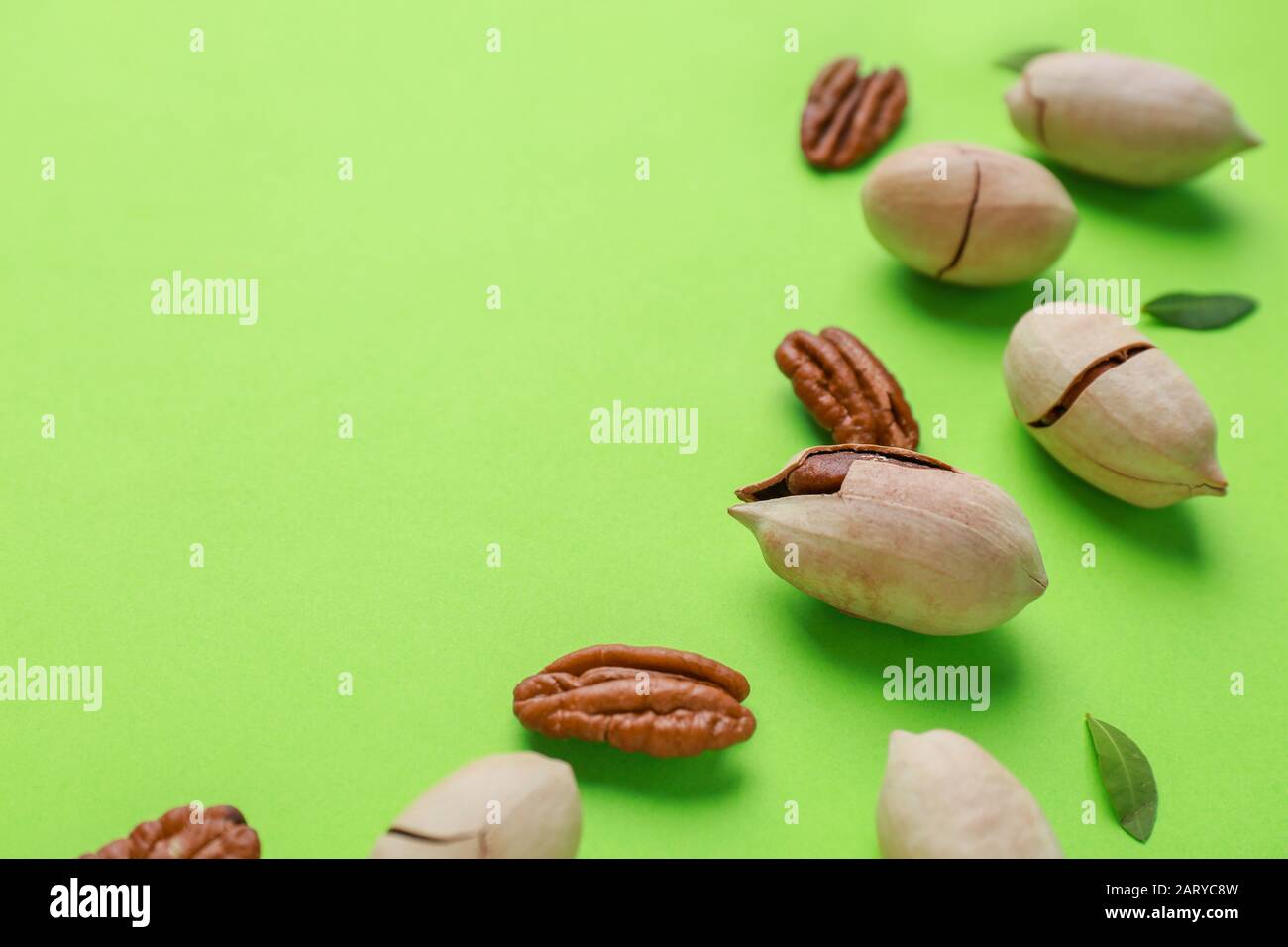 Tasty pecan nuts on color background Stock Photo