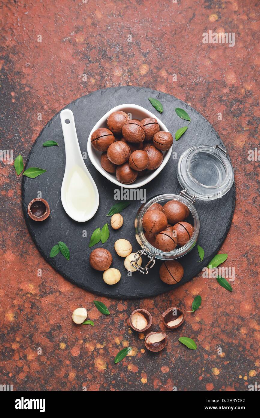 Tasty macadamia nuts on color background Stock Photo