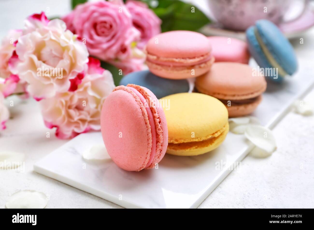 Different tasty macarons on white table Stock Photo