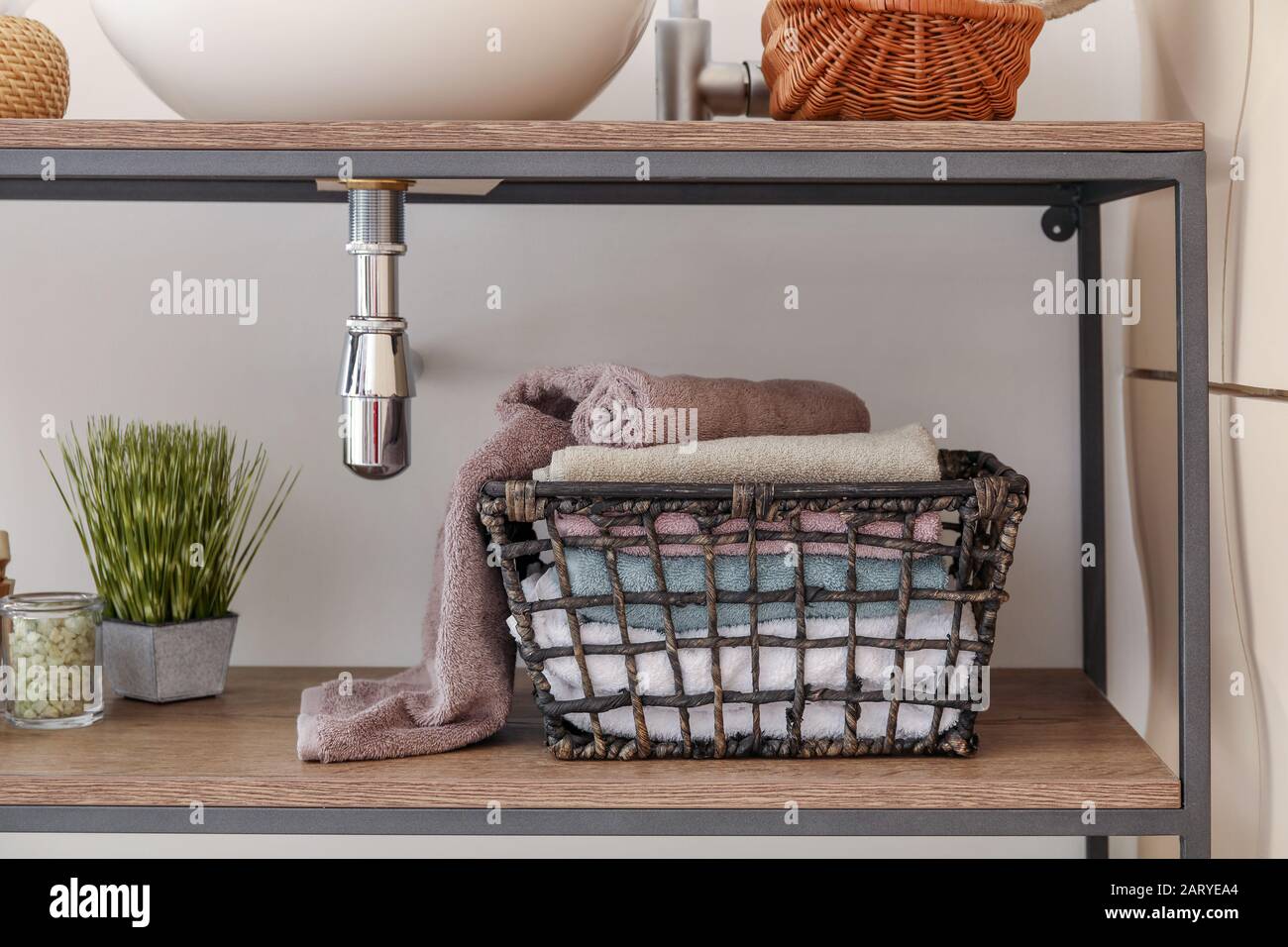 Basket with clean towels under sink in bathroom Stock Photo Alamy