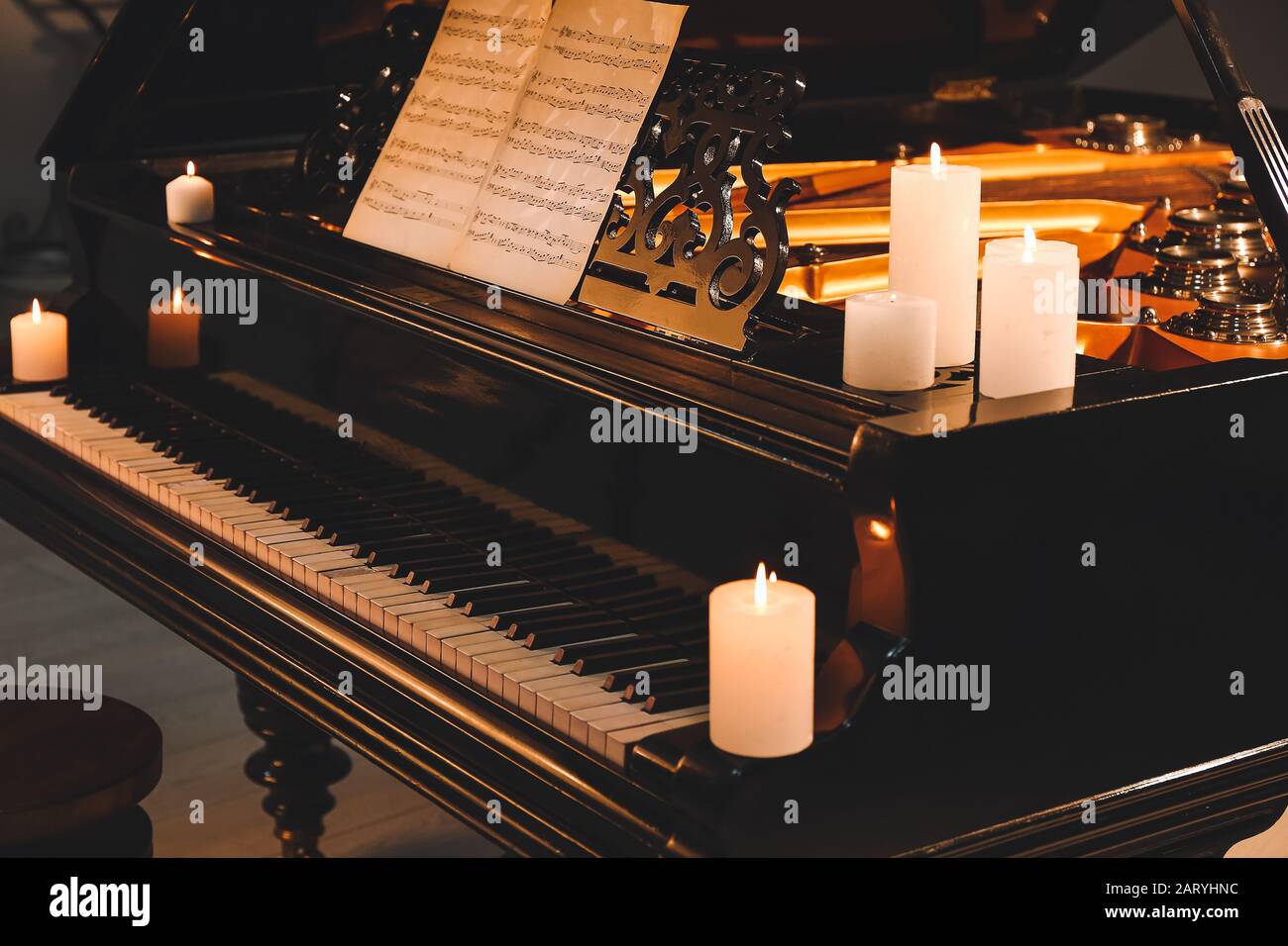 Stylish grand piano with burning candles in evening Stock Photo Alamy