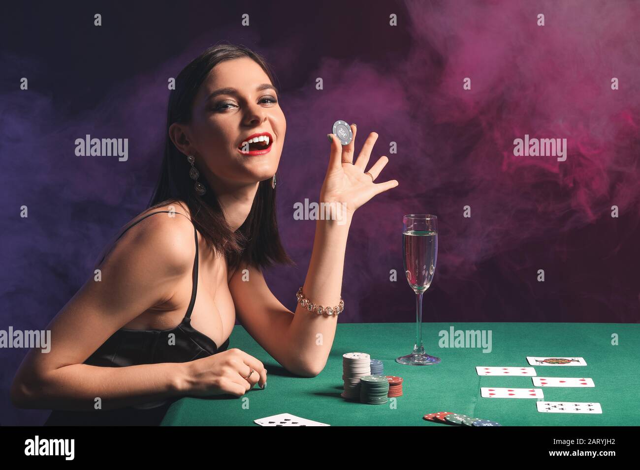 Female poker player at table in casino Stock Photo