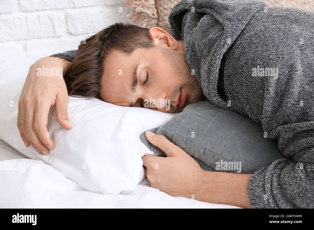 Handsome man in bathrobe sleeping on bed Stock Photo Alamy
