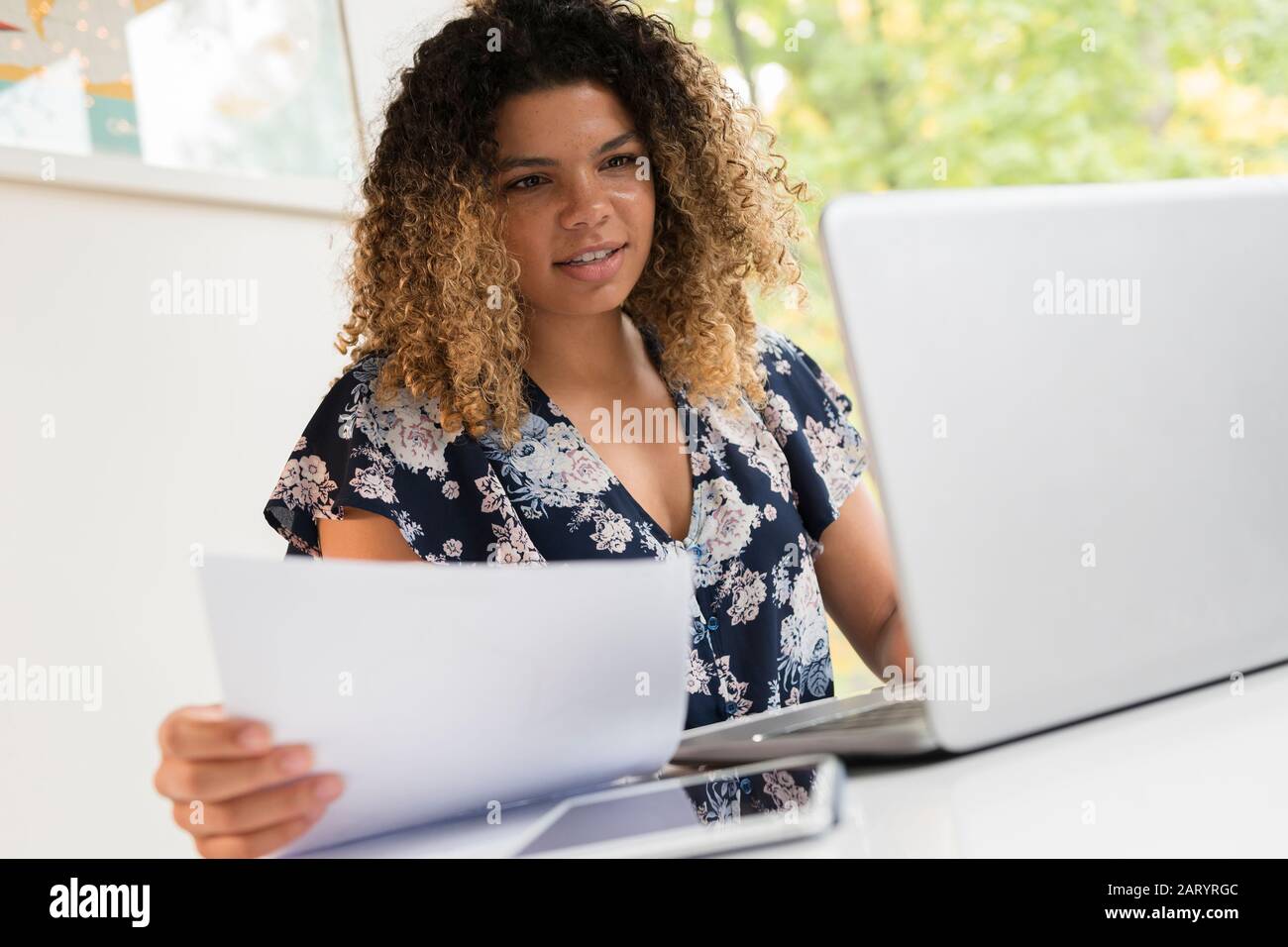 Smiling woman working on laptop Stock Photo