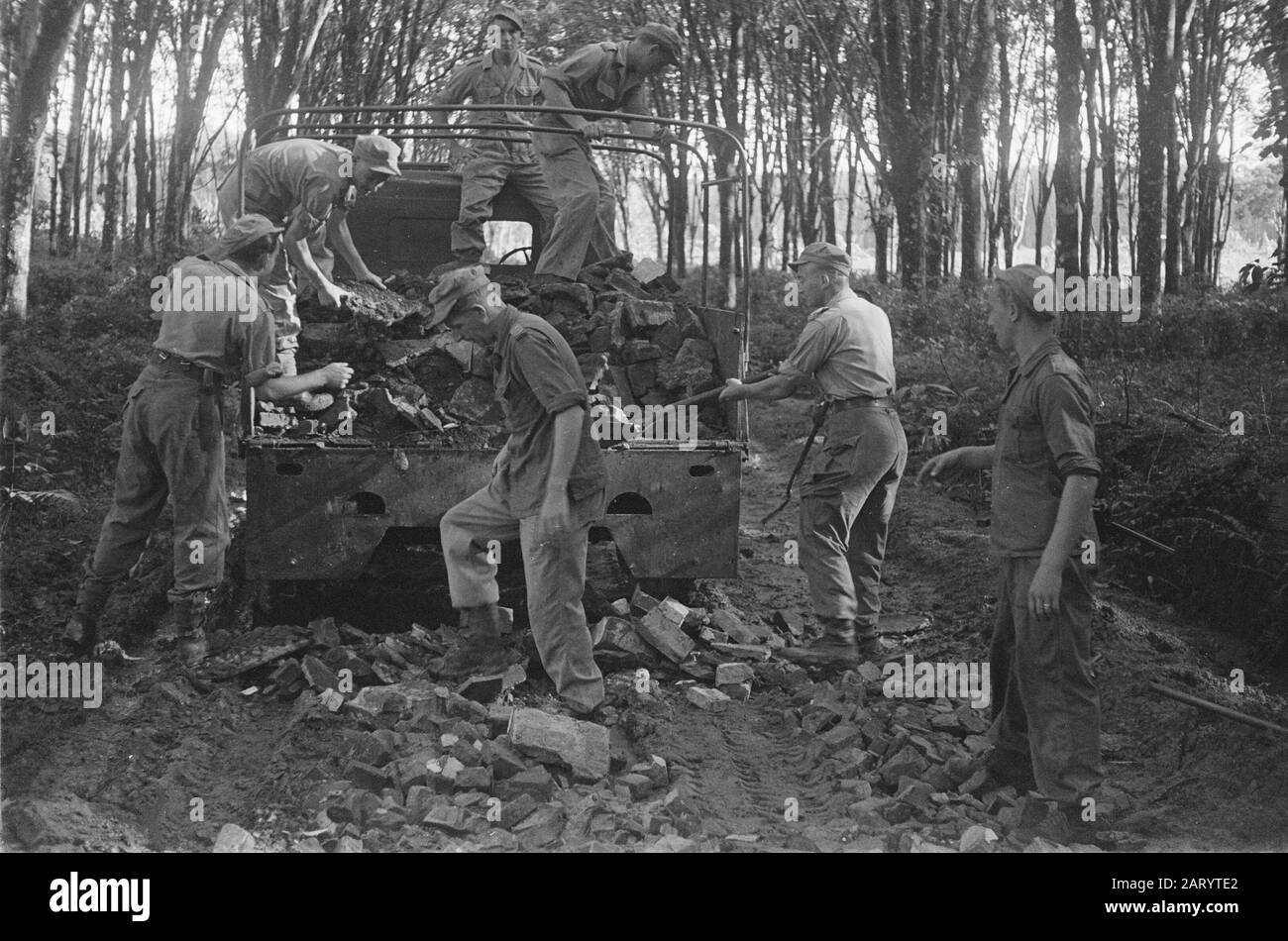 Unknown [a.o. medical care]  Military debris is taken out of a truck for the hardening of a road Date: 1948 Location: Indonesia, Dutch- India Stock Photo