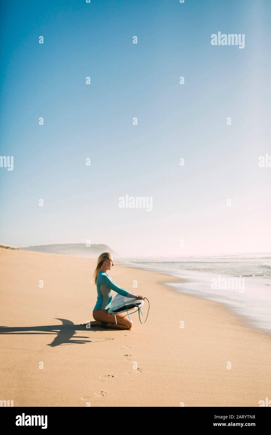 Woman kneeling on surfboard hi-res stock photography and images - Alamy