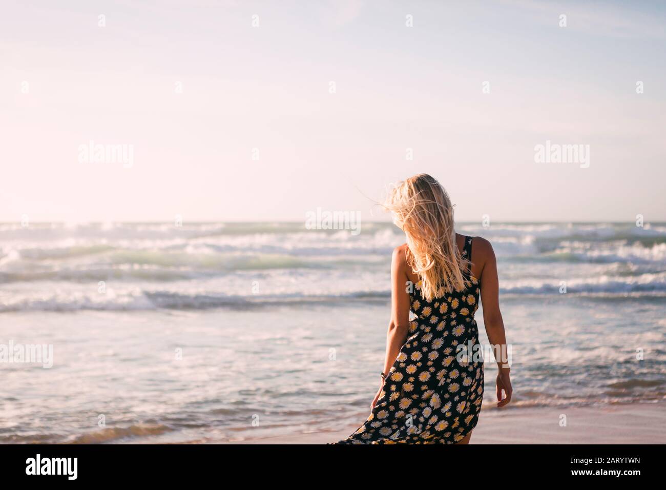 Woman wearing black dress on beach Stock Photo