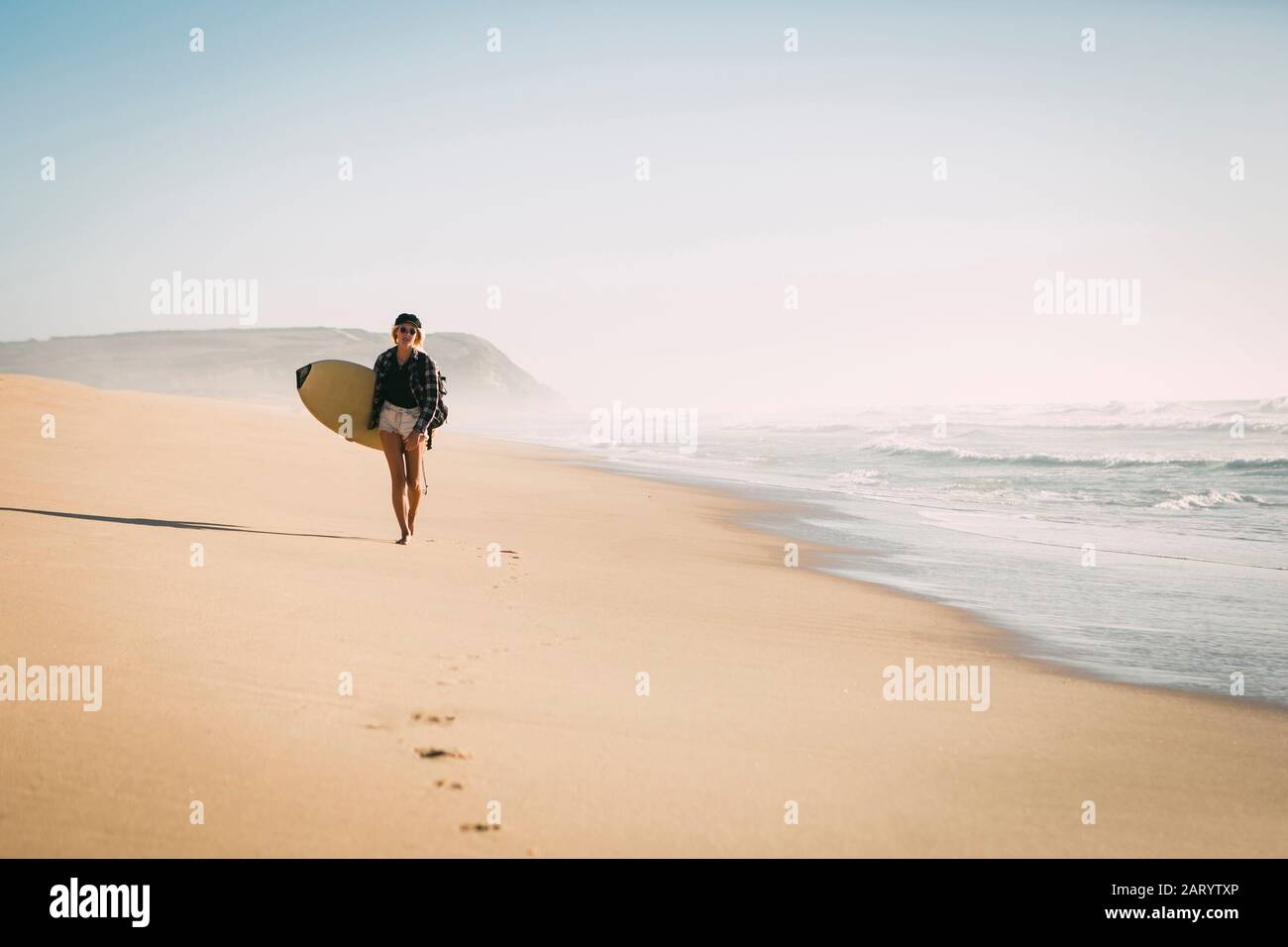 Woman holding surfboard hi-res stock photography and images - Alamy
